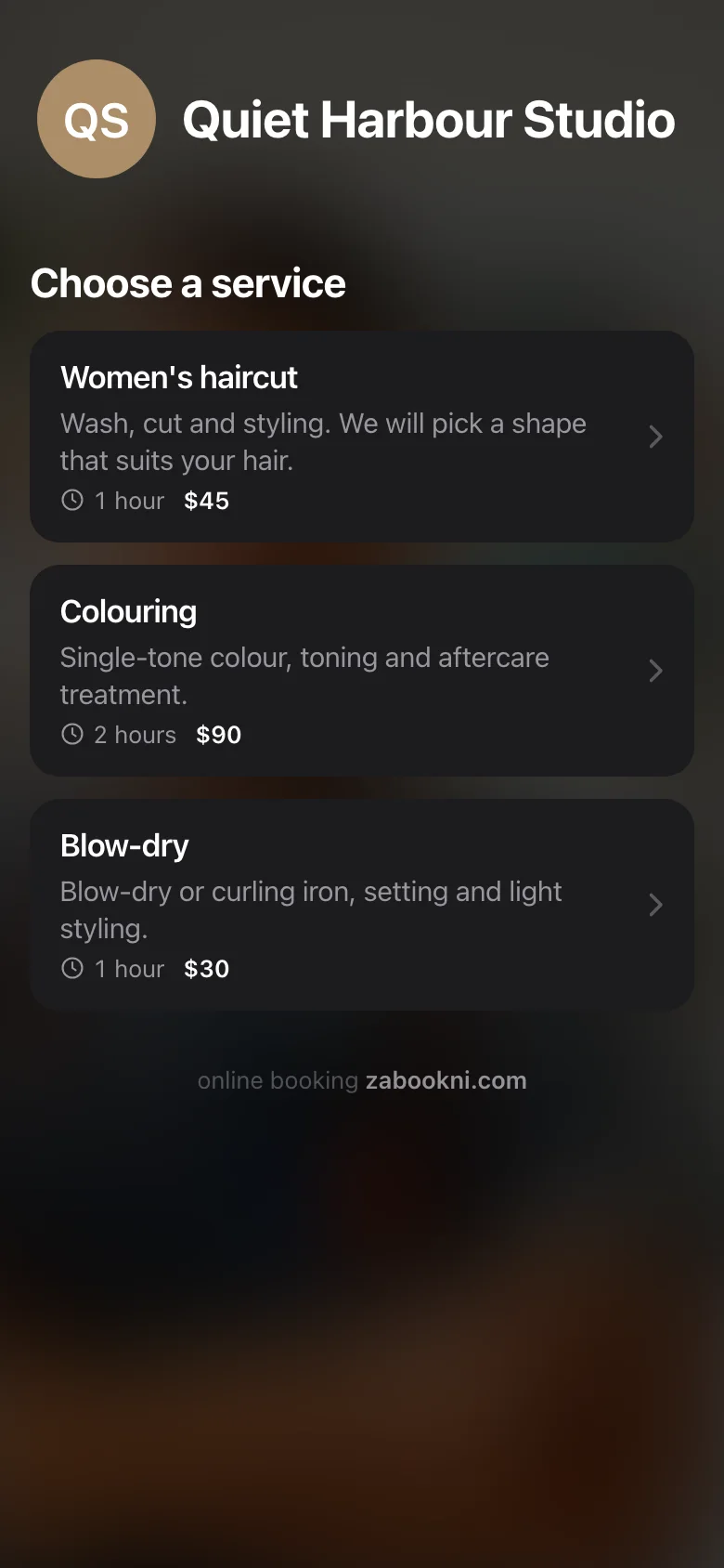 The same page in the dark theme over the salon's own background photo